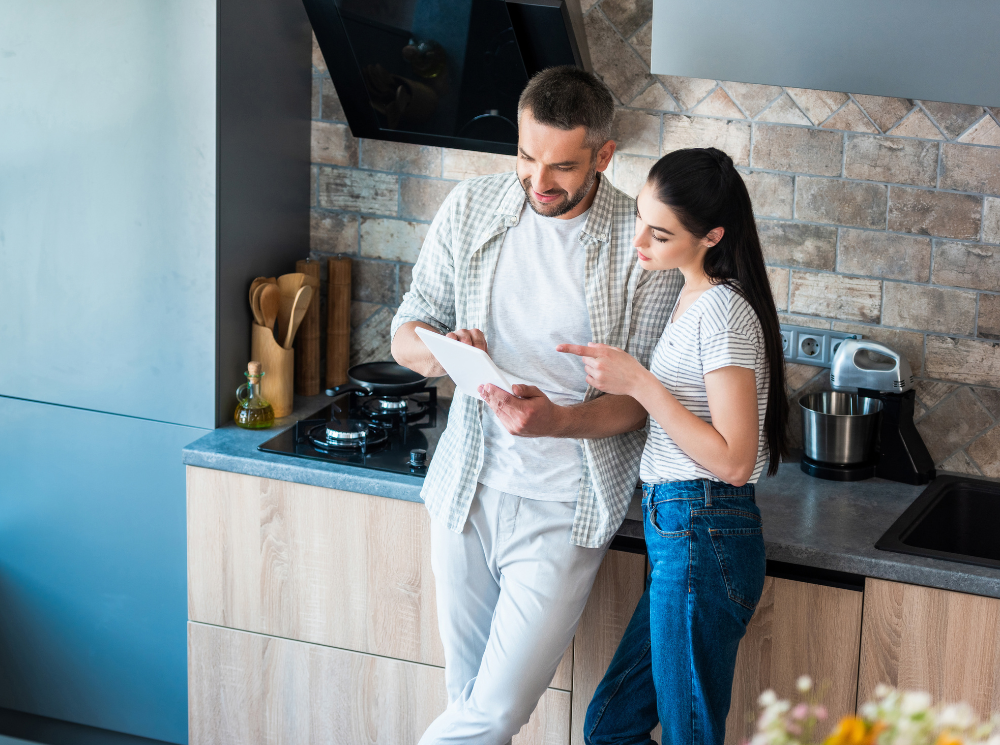 couple exploring the smart technology on their home appliances