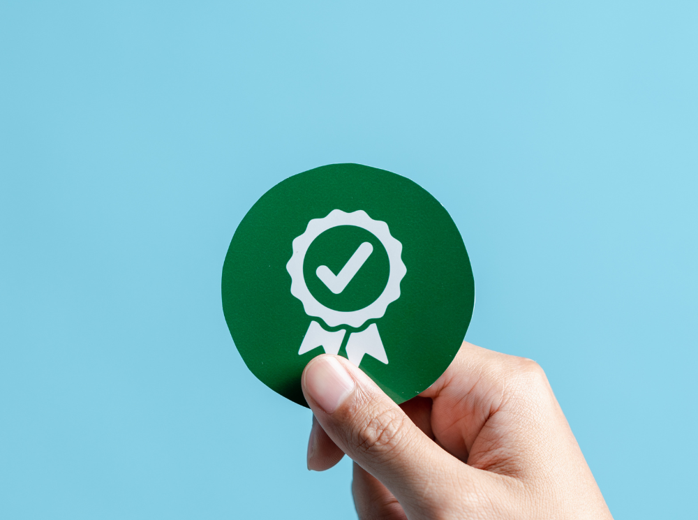 a green icon showing product quality assurance