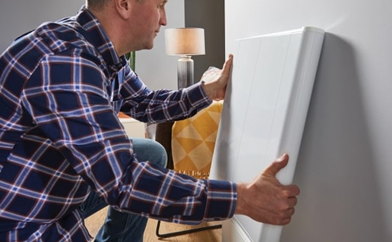 a man installing an electric radiator 