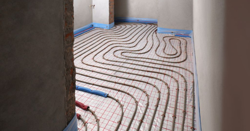 Installation of an underfloor heating system, showcasing innovative kitchen heating ideas for a contemporary kitchen.