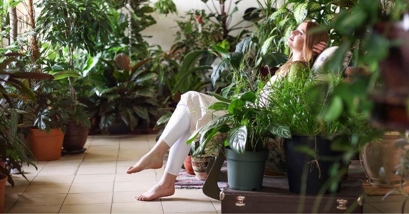 Woman relaxing in her garden room with a calming atmosphere