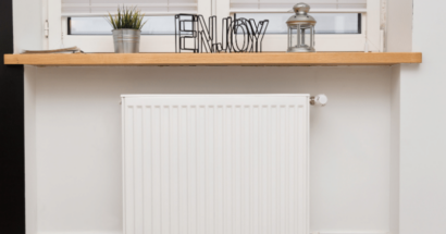 Radiator installed beneath a window in a traditional setting