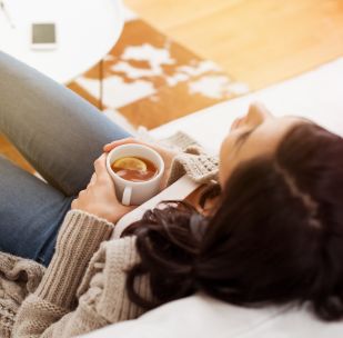 a woman refreshing while drinking her coffee