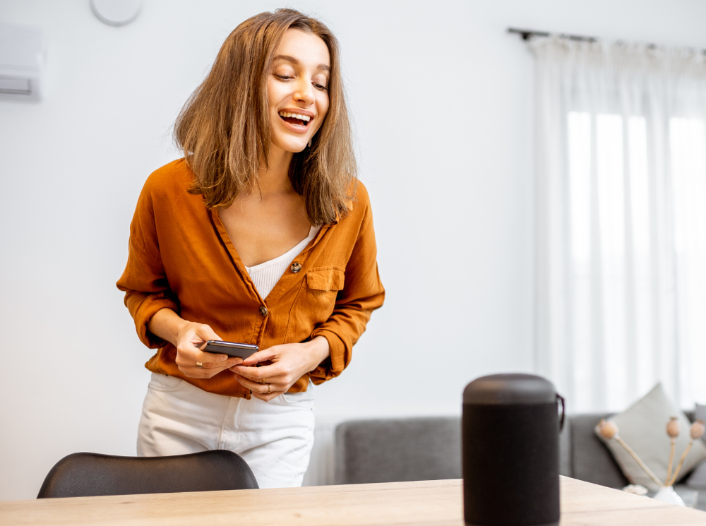 woman controlling an electric radiator using a voice activation feature