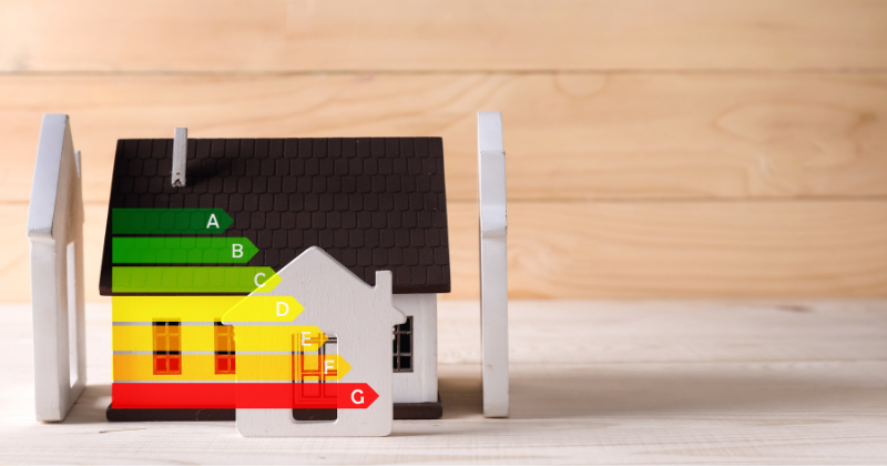 A miniature wooden house featuring an illustration of an energy-efficient heating system.