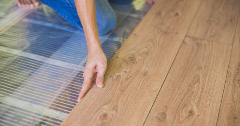 Infrared heating panels being installed by a man