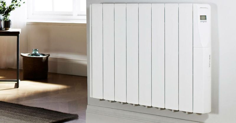 A white electric radiator wall-mounted in a living room alternative to gas boilers