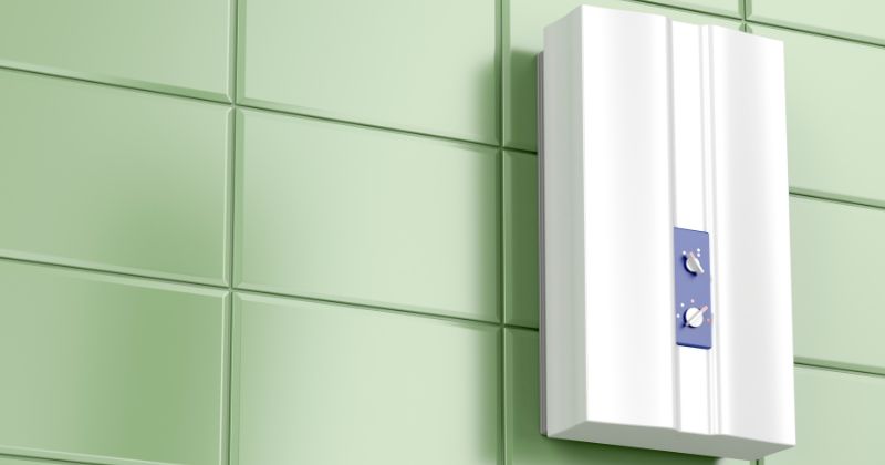 A modern electric water heater wall-mounted in a tiled bathroom