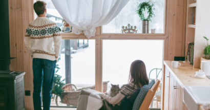 Father and daughter by winter window indoors